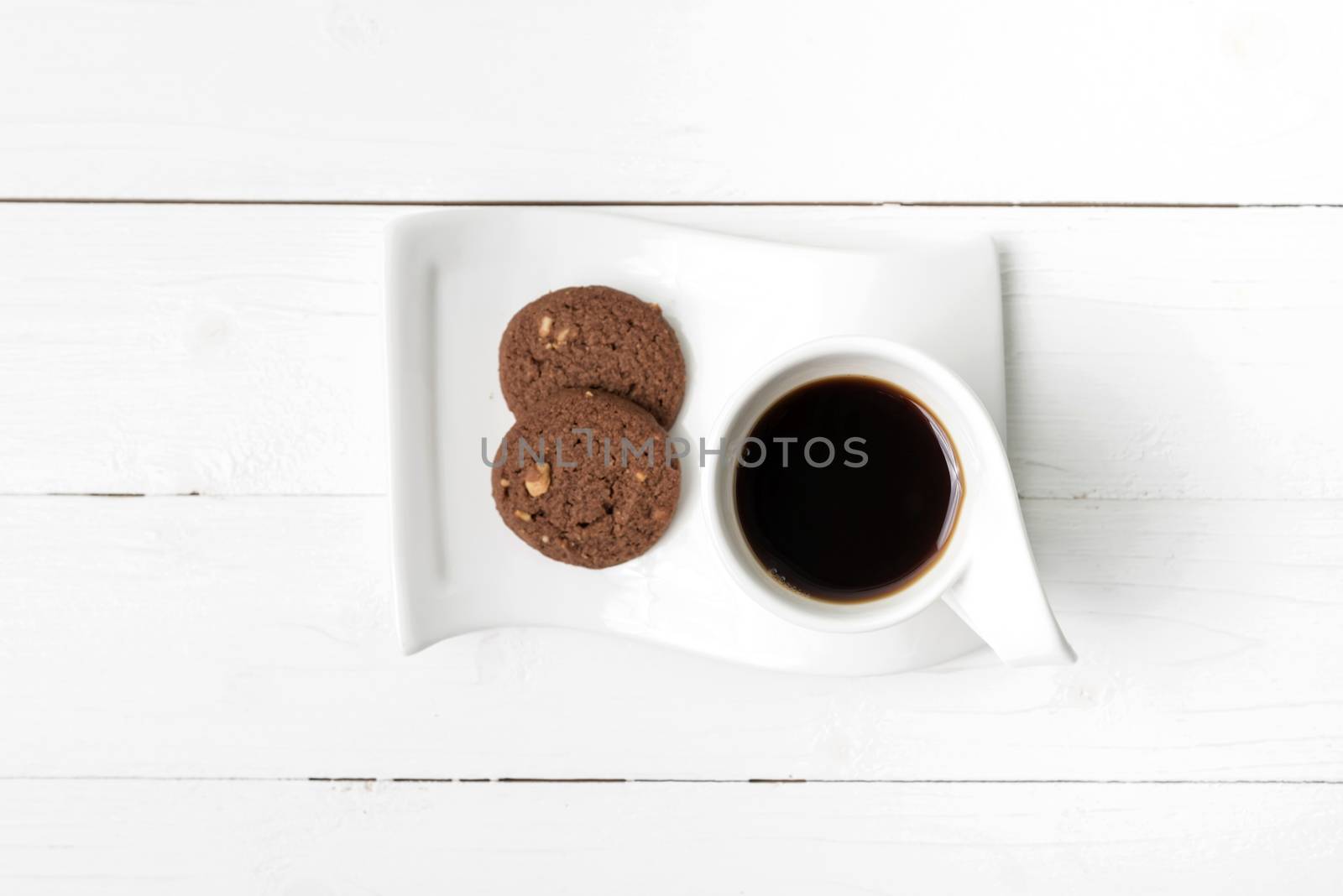 coffee cup with cookie on white wood background