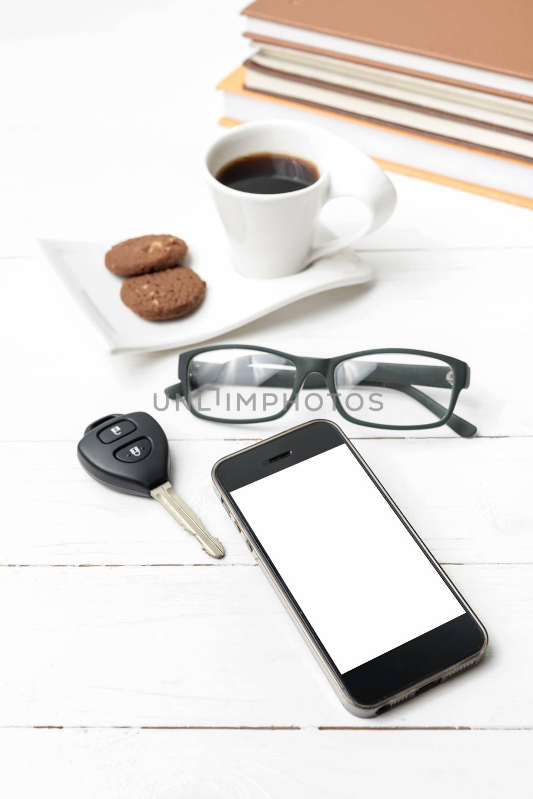 coffe cup with cookie,phone,car key,eyeglasses and stack of book by ammza12