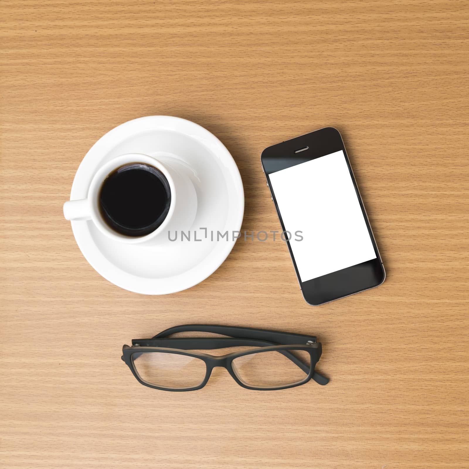 coffee cup and phone and eyeglasses on wood background