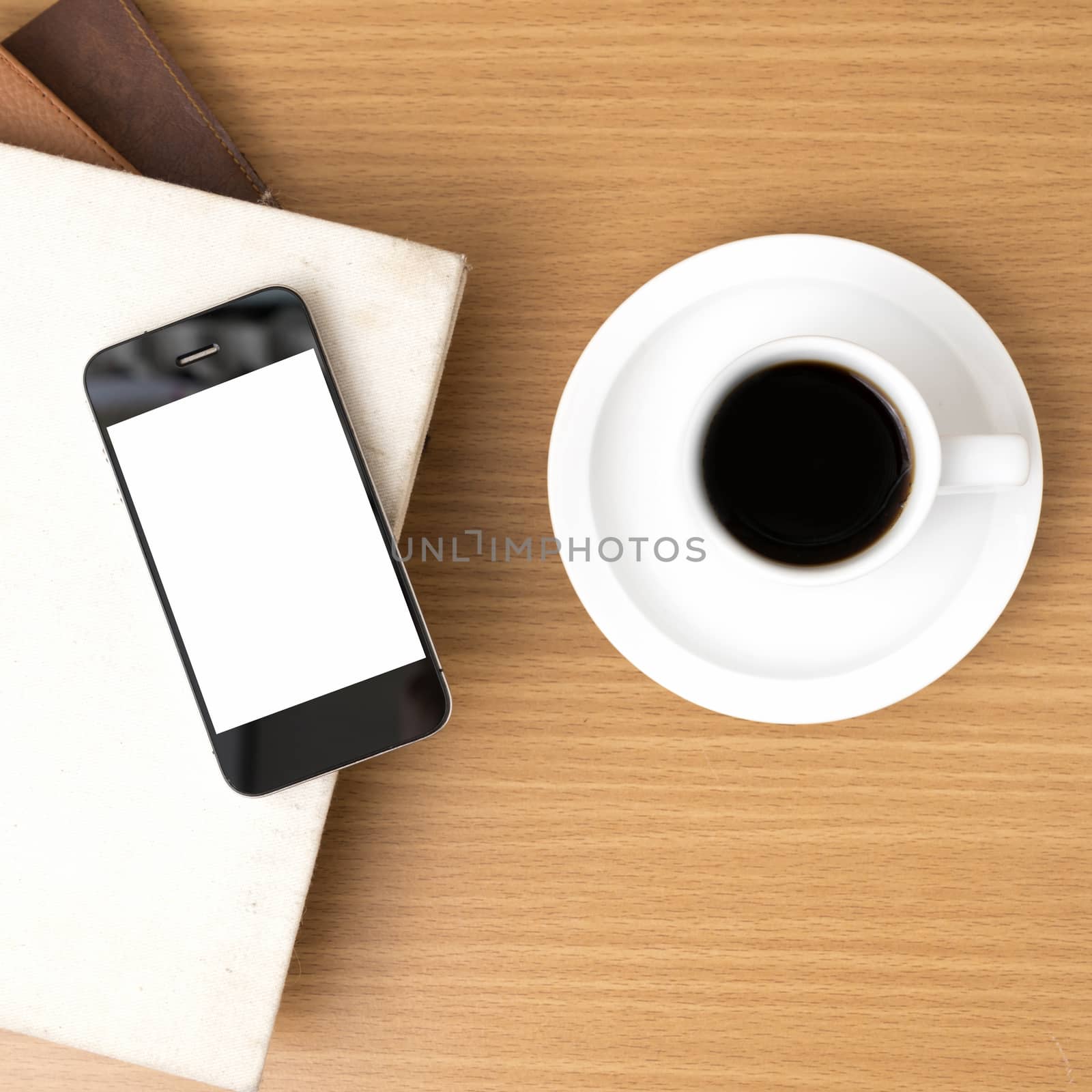 coffee cup and phone and stack of book on wood background