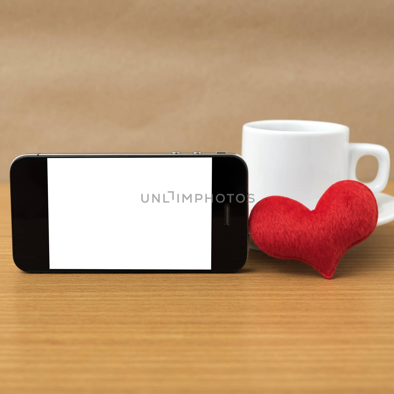 coffee cup and phone and heart on wood background