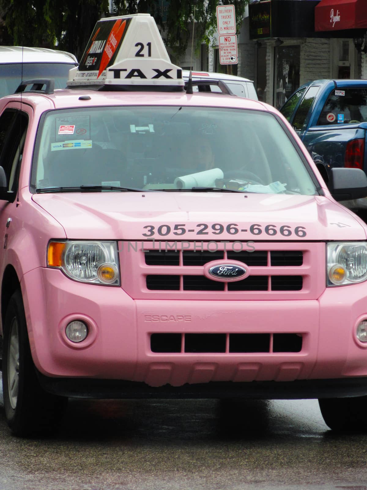 Key West, USA - August 6 2012: Ford Escape SUV Pink Taxi in the streets of downtown Key West in southern Florida
