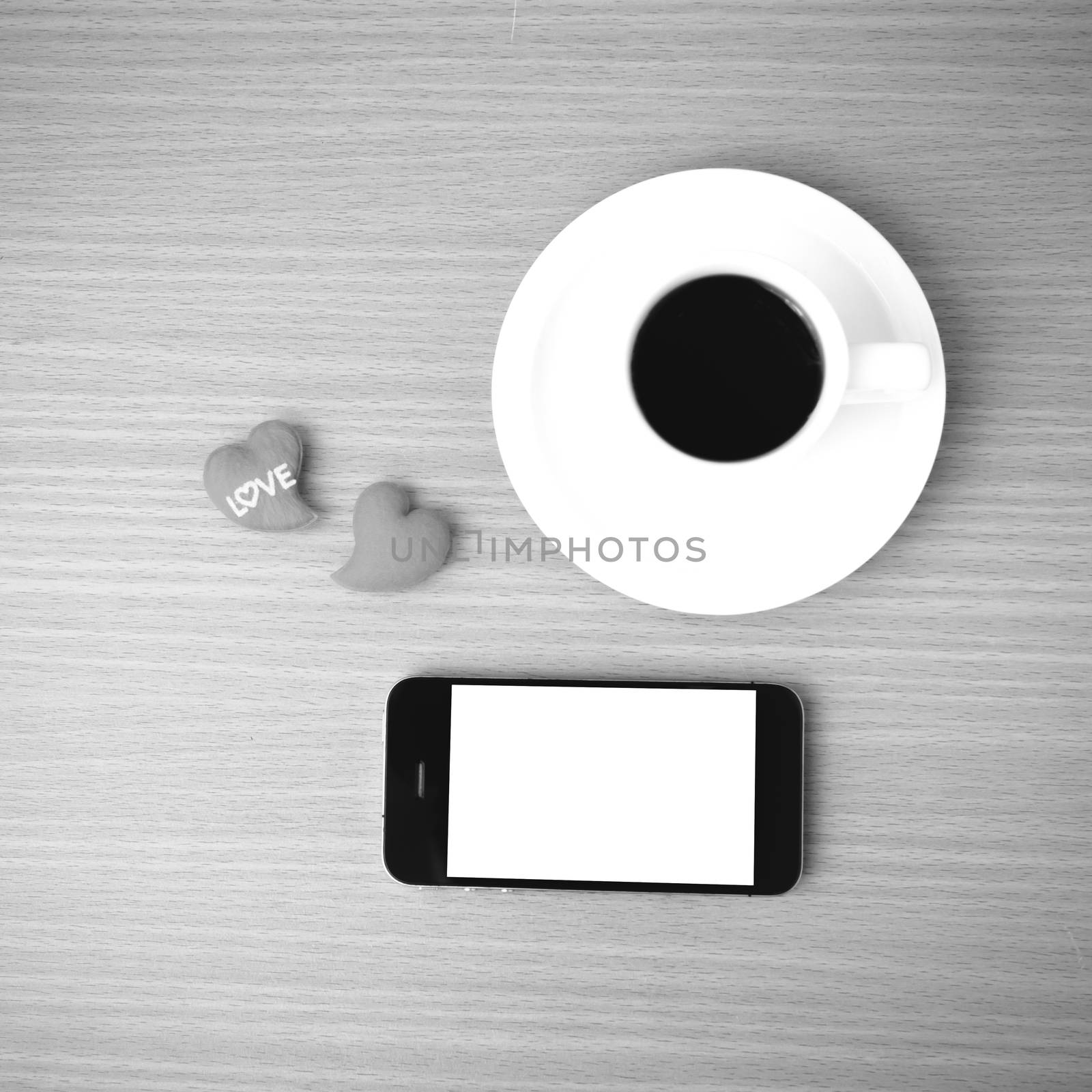 coffee cup and phone and heart on wood background black and white color