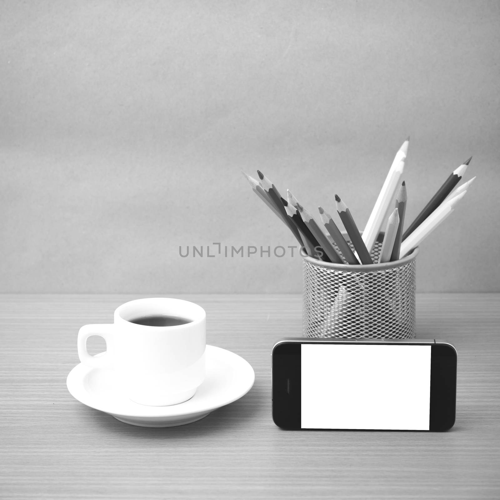 coffee cup and phone with color pencil on wood background black and white color