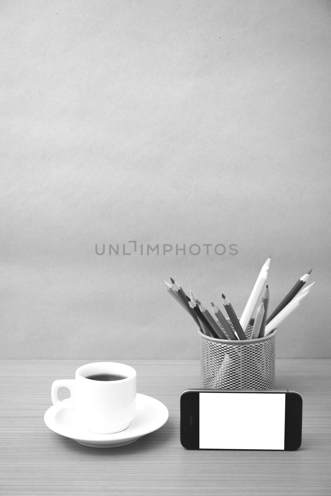 coffee cup and phone with color pencil on wood background black and white color