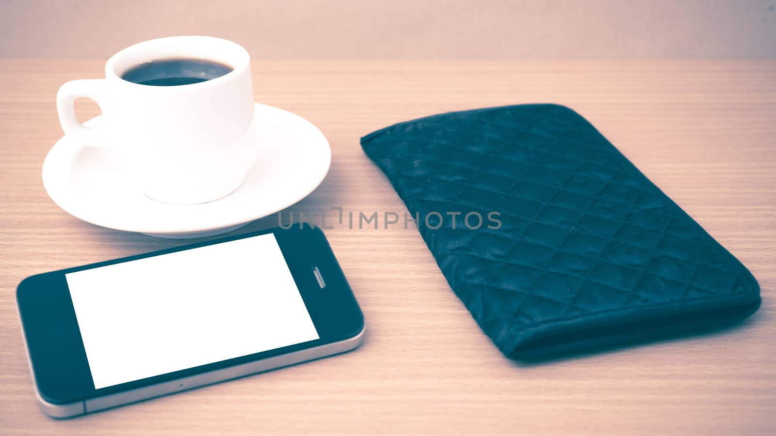 coffee cup and phone and wallet on wood table vintage style