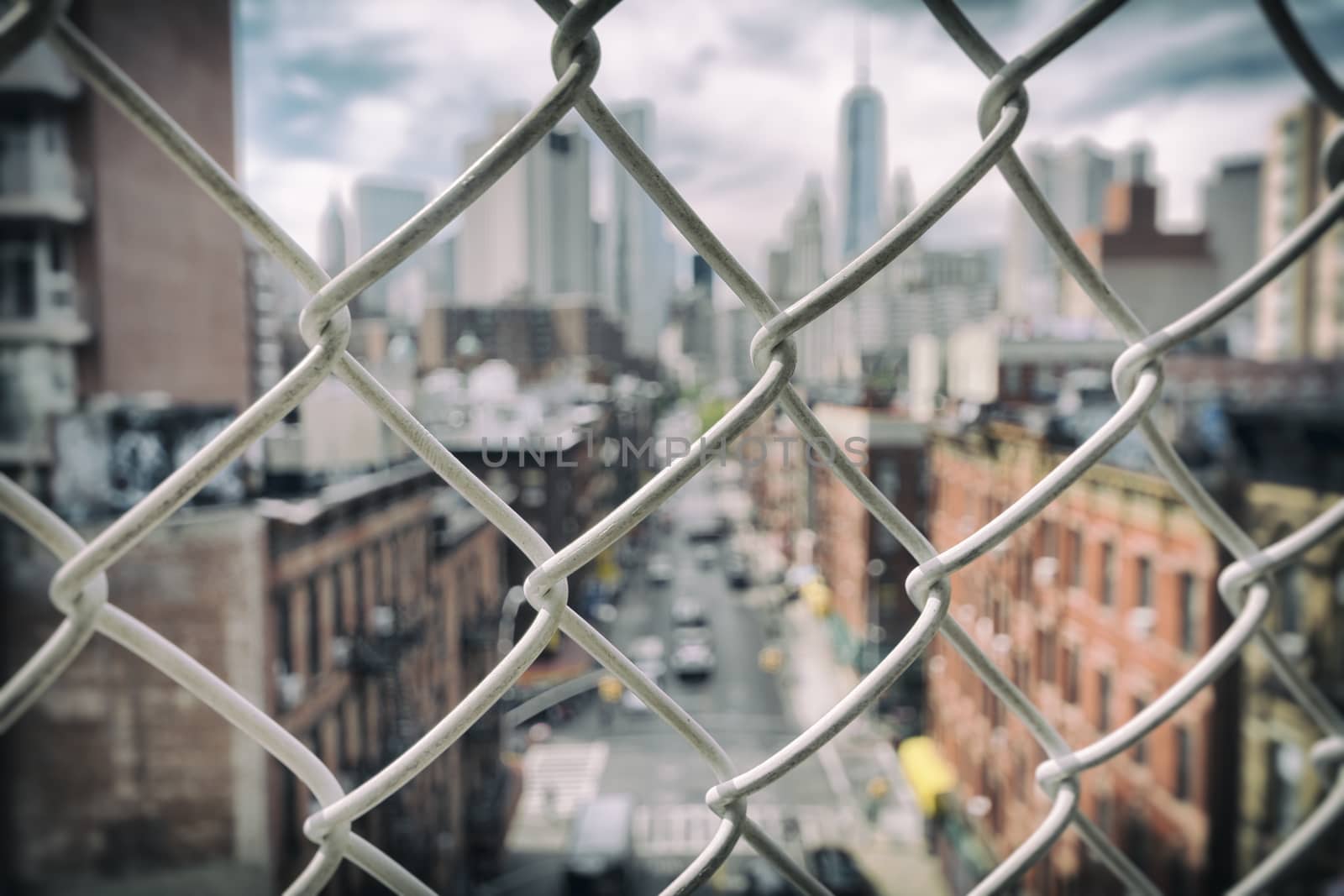 Focus on a fence in front of the New York skyline
