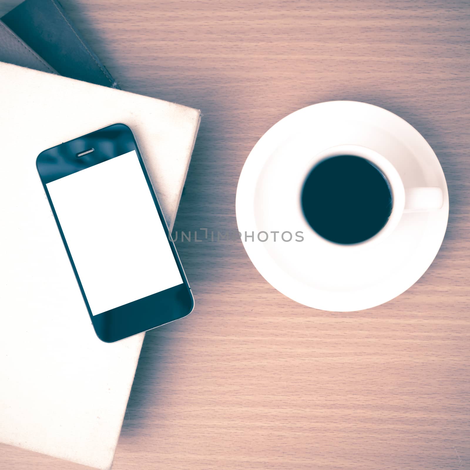 coffee cup and phone and stack of book on wood background vintage style