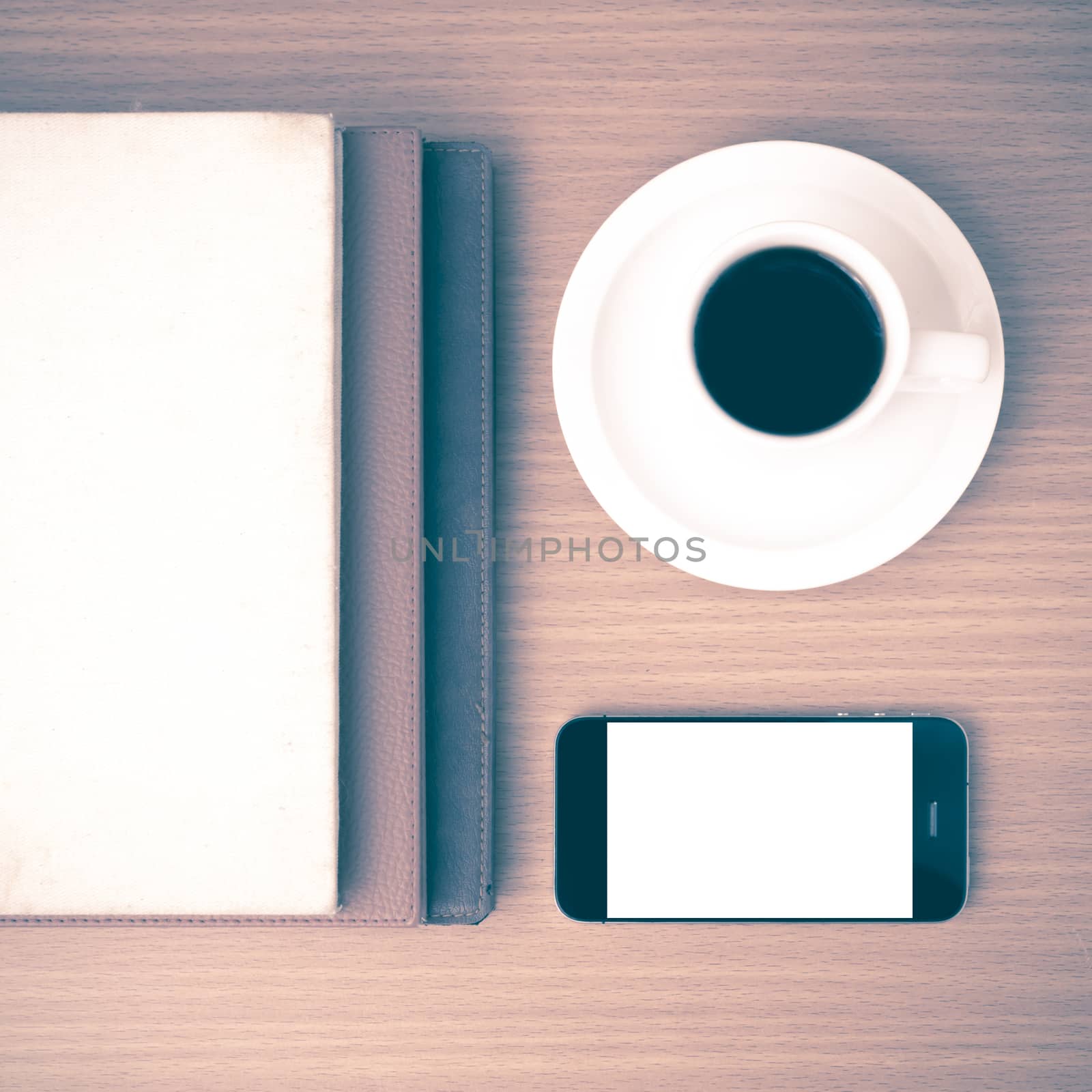 coffee cup and phone and stack of book on wood background vintage style