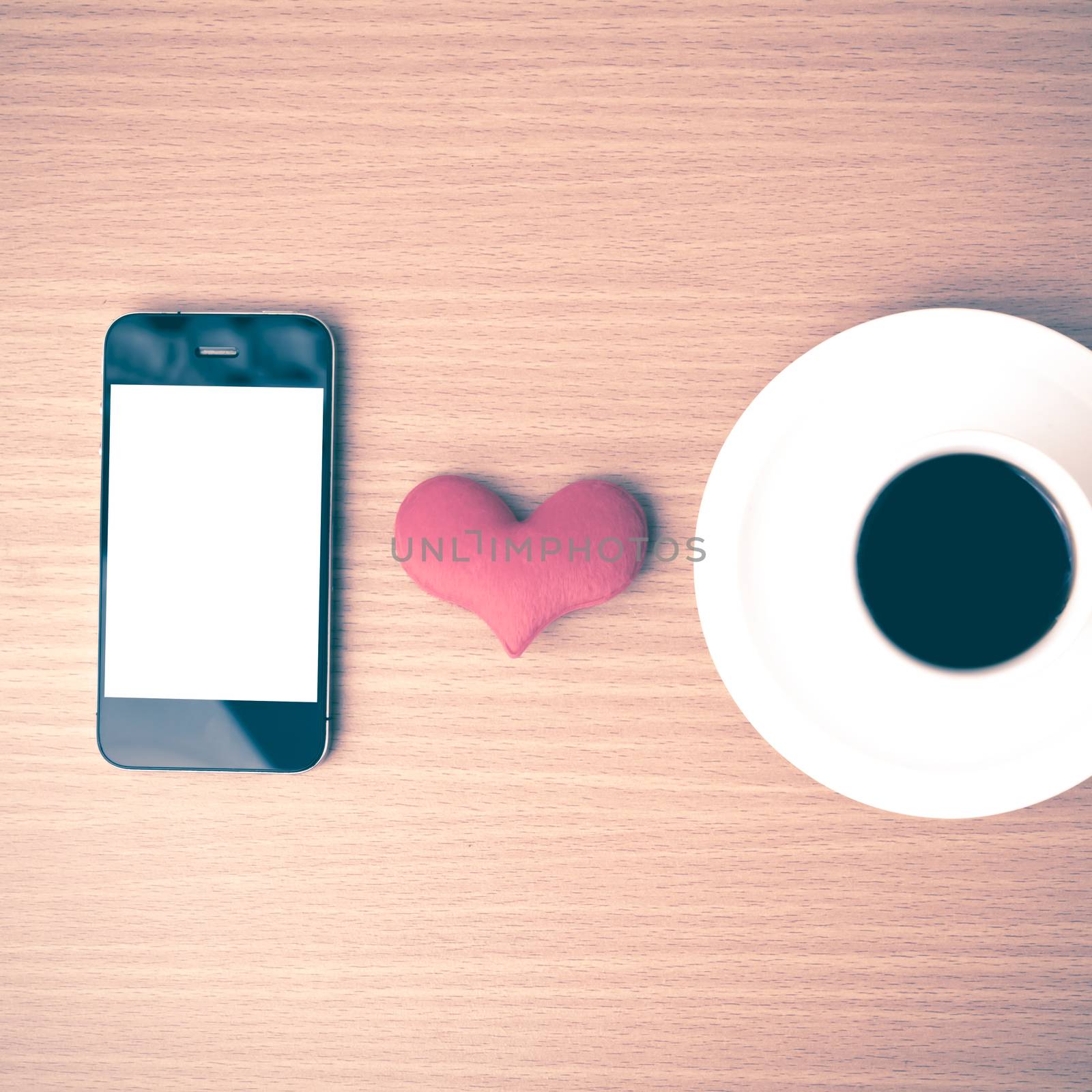 coffee cup and phone and heart on wood background vintage style