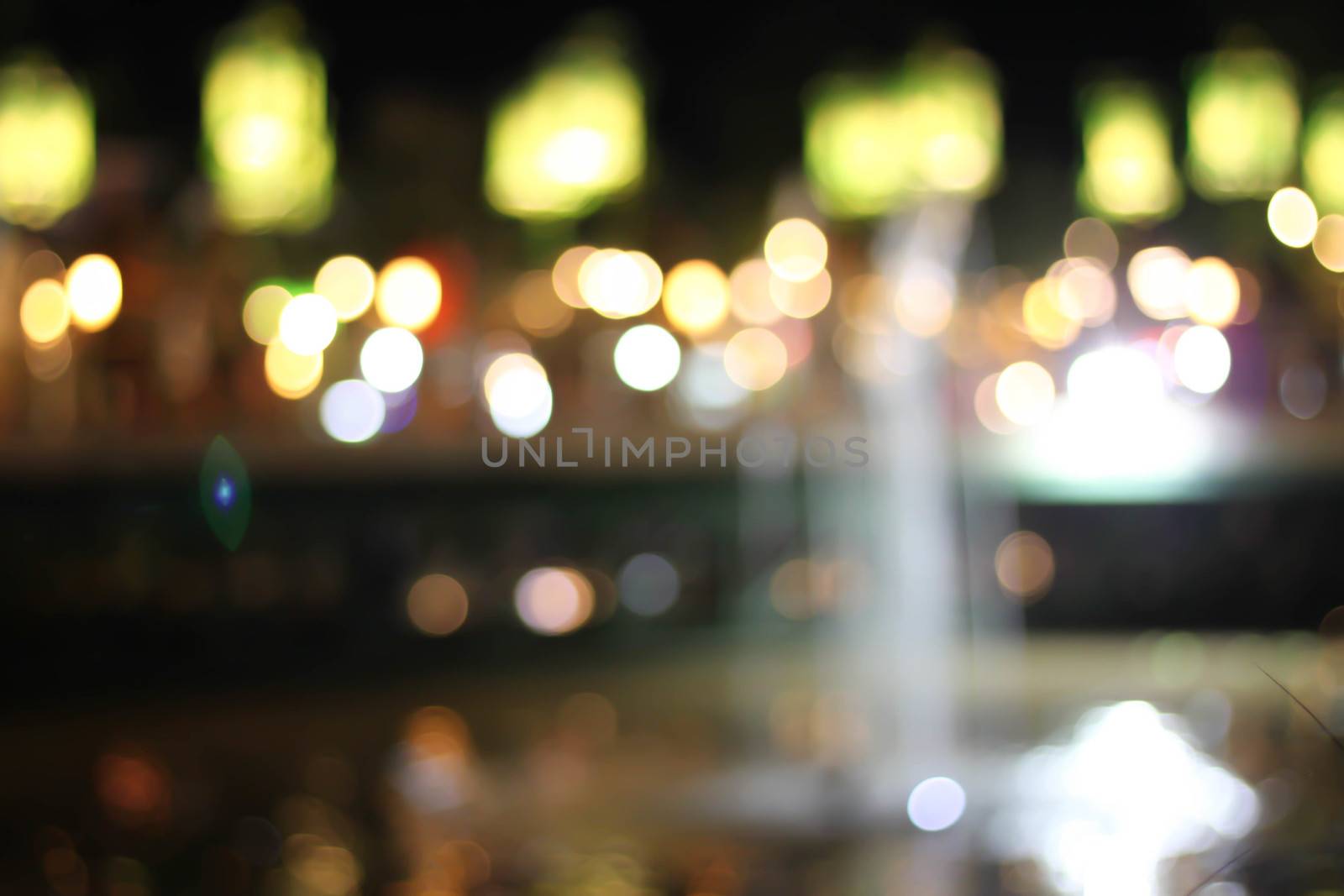 Blurred background bokeh night with a fountain.