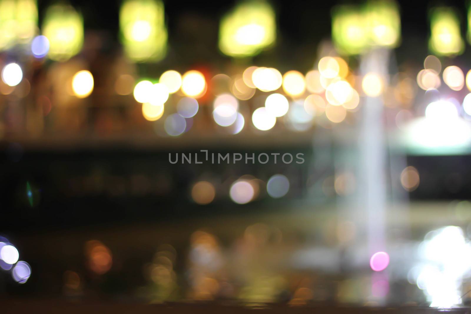 Blurred background bokeh night with a fountain.