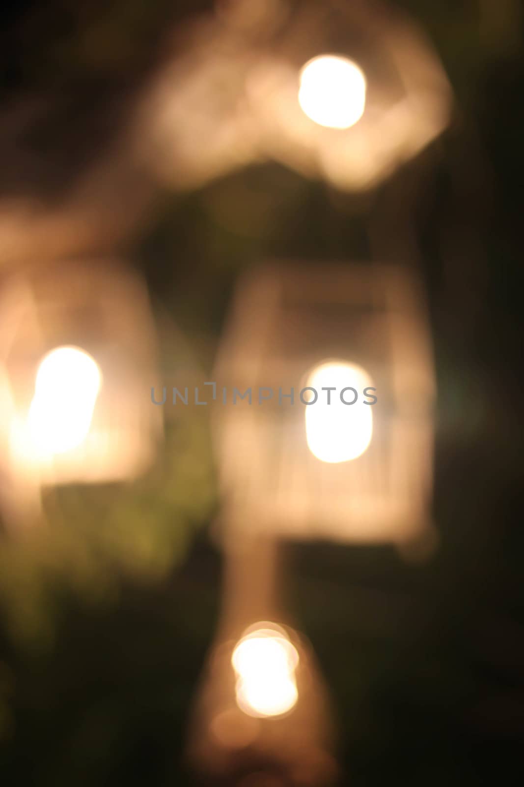 Light wooden cage on a tree blurred background.