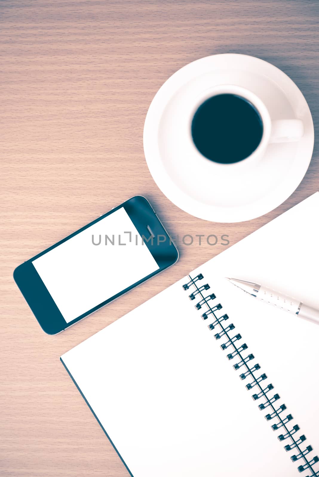 coffee cup and phone and notepad on wood background vintage style