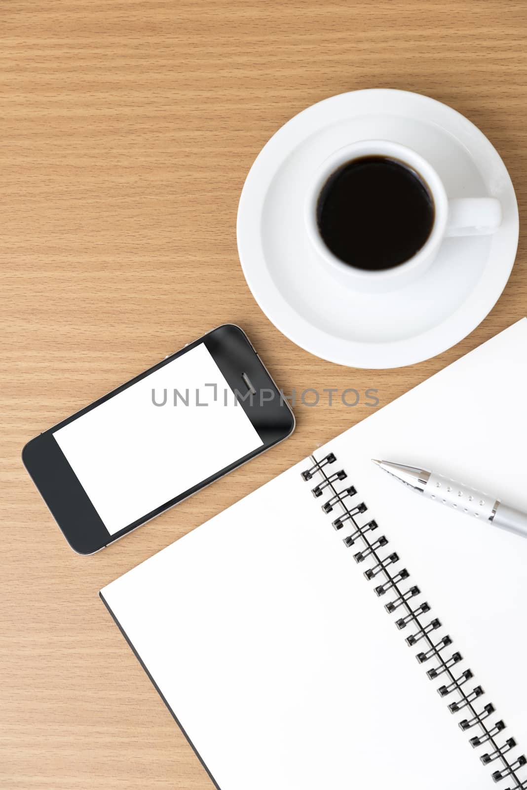 coffee cup and phone and notepad on wood background