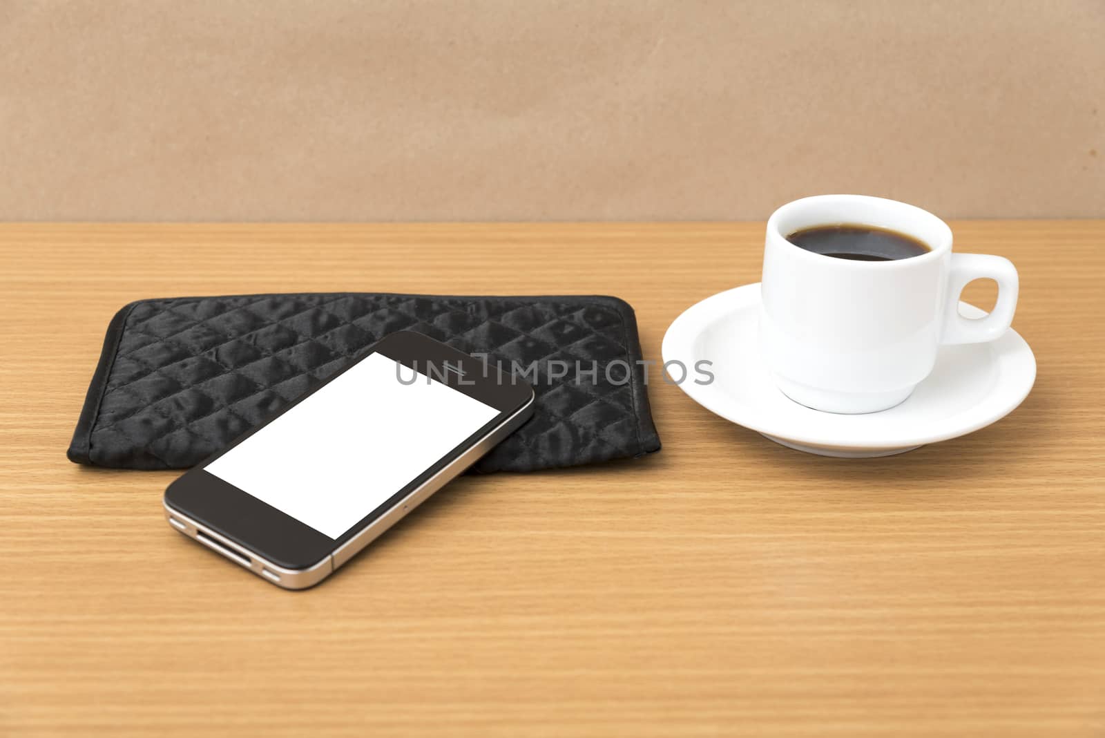 coffee cup and phone and wallet on wood table