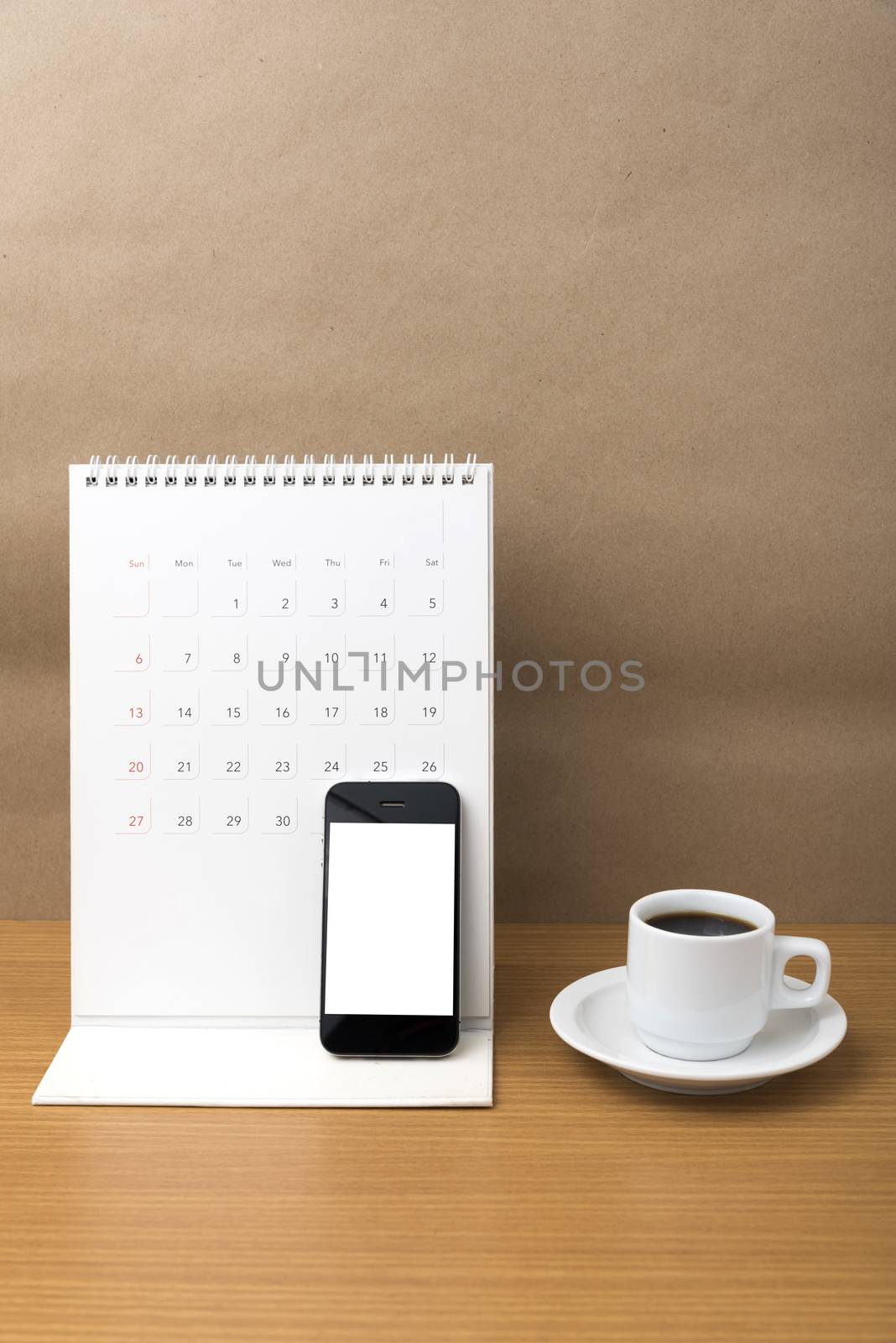 coffee cup and phone and calendar on wood background