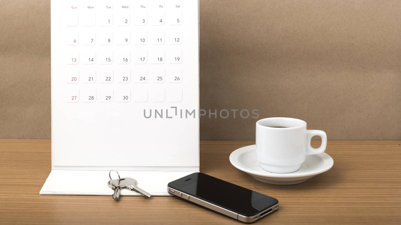 coffee,phone,key and calendar on wood table background