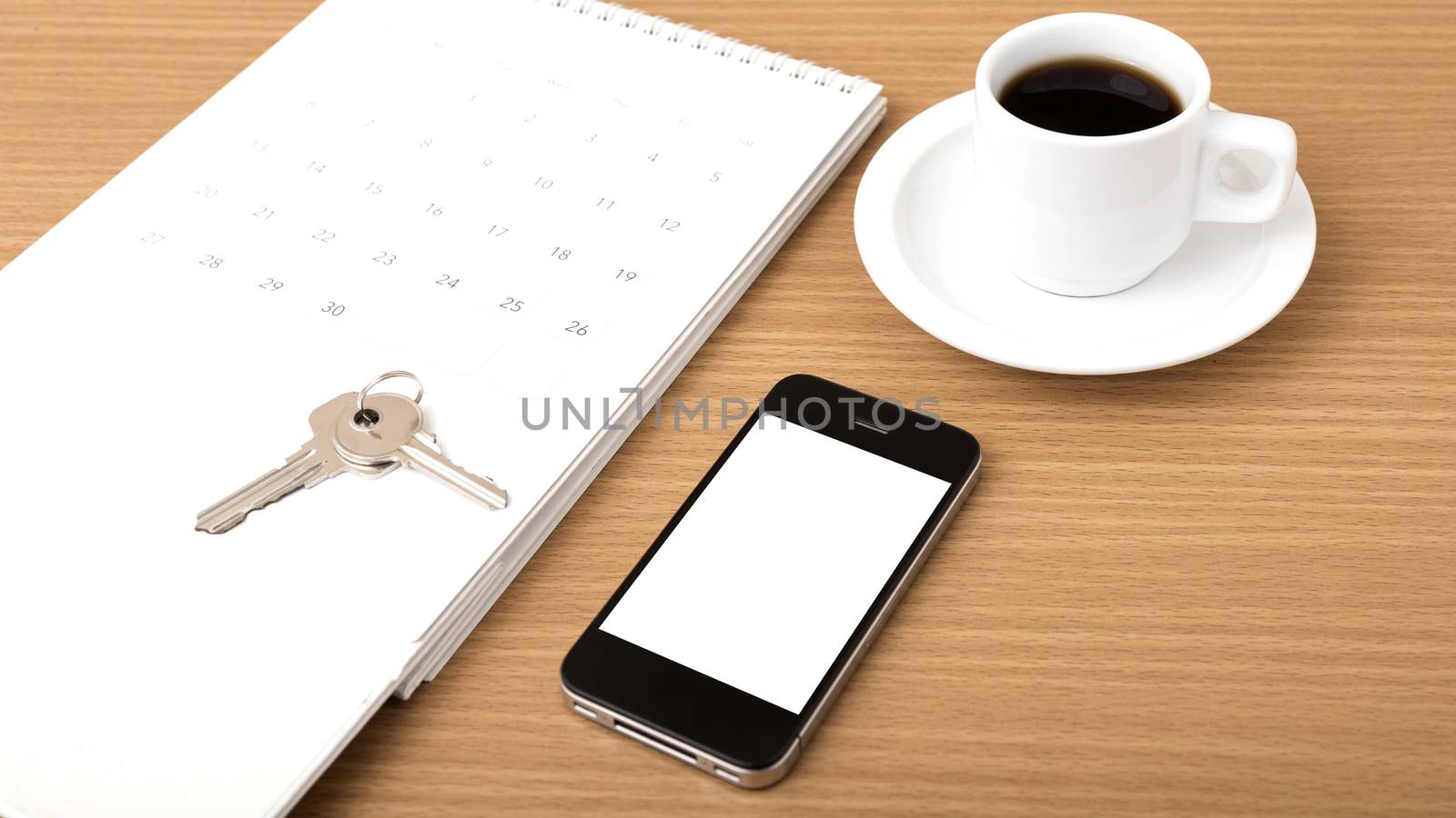 coffee,phone,key and calendar on wood table background