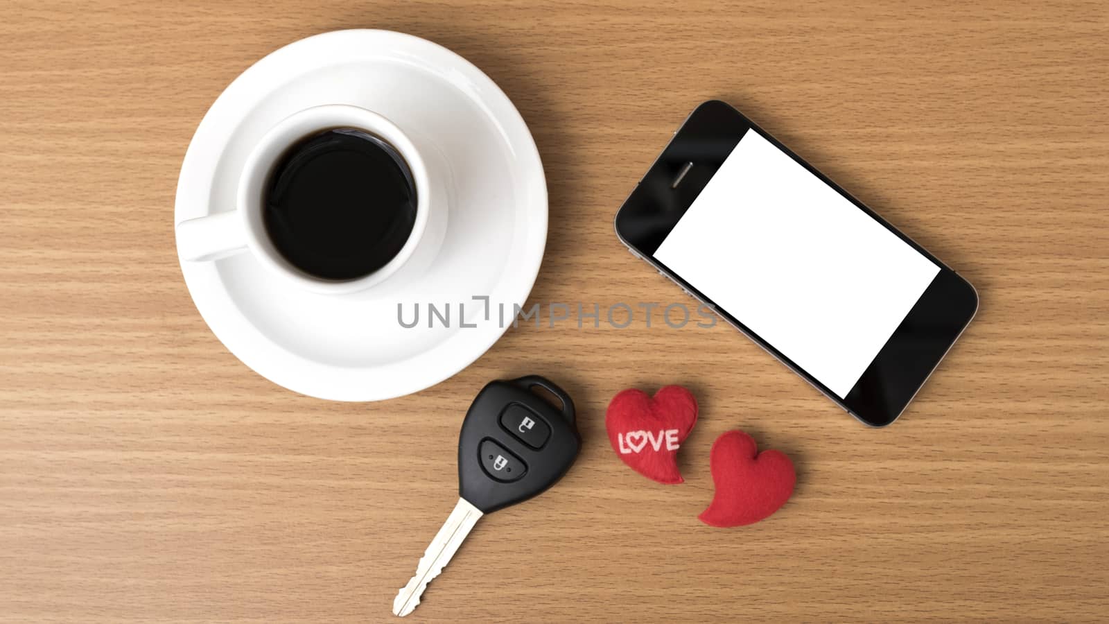 coffee phone car key and heart on wood table background