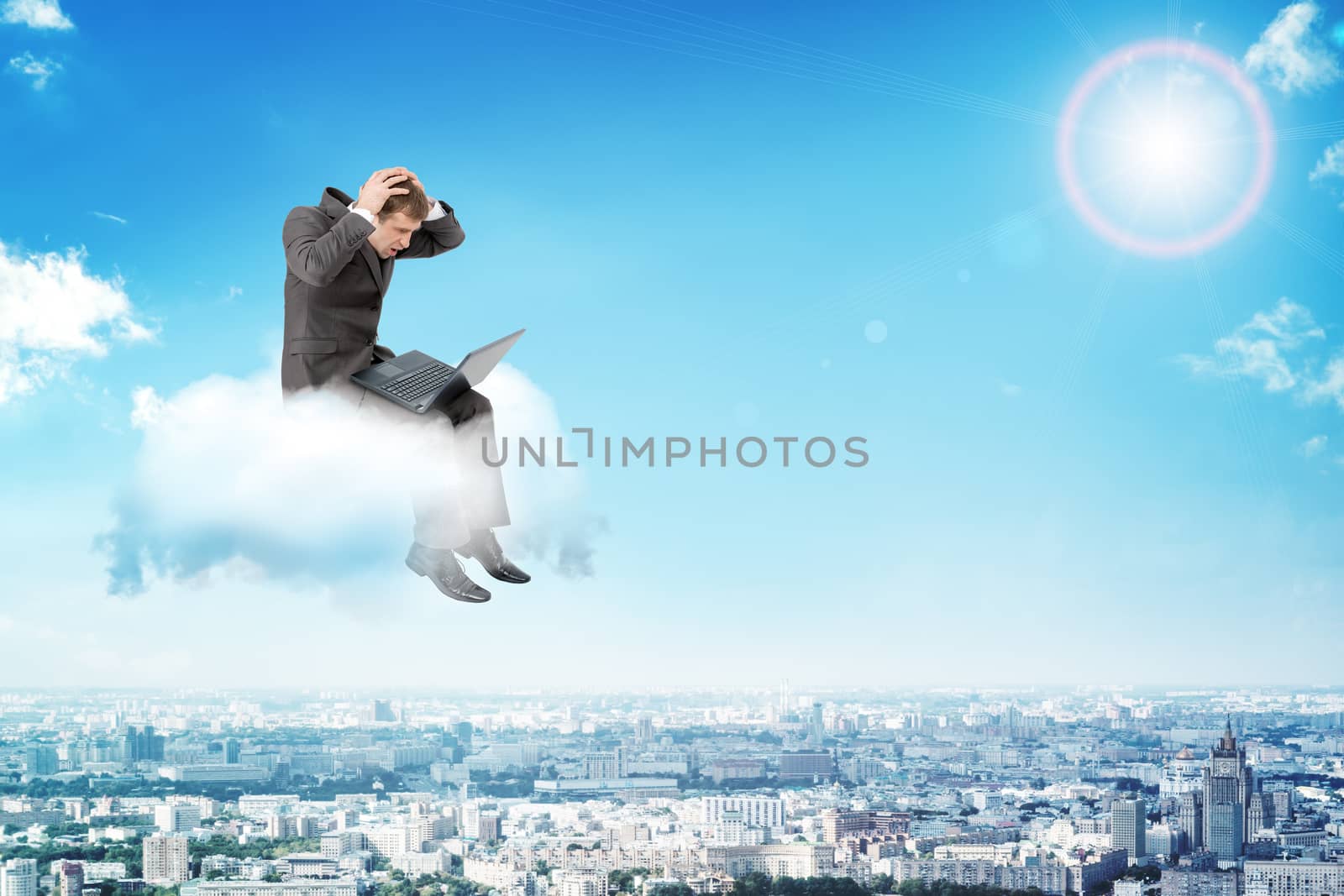 Confused businessman working on laptop and sitting on cloud above city