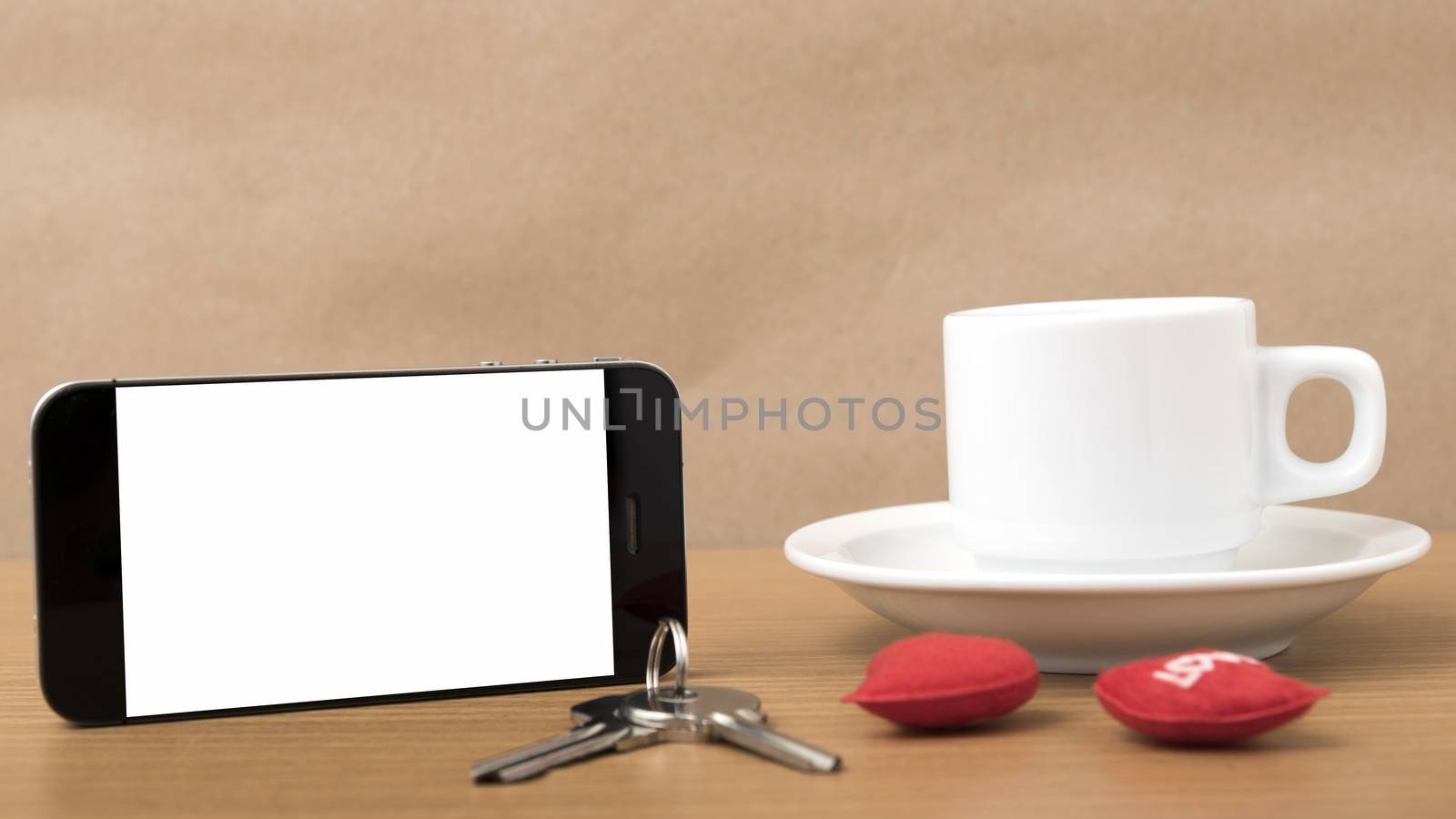 coffee phone key and heart on wood table background