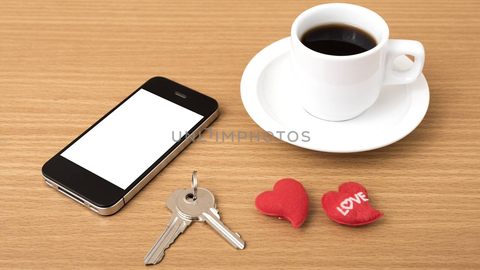 coffee phone key and heart on wood table background