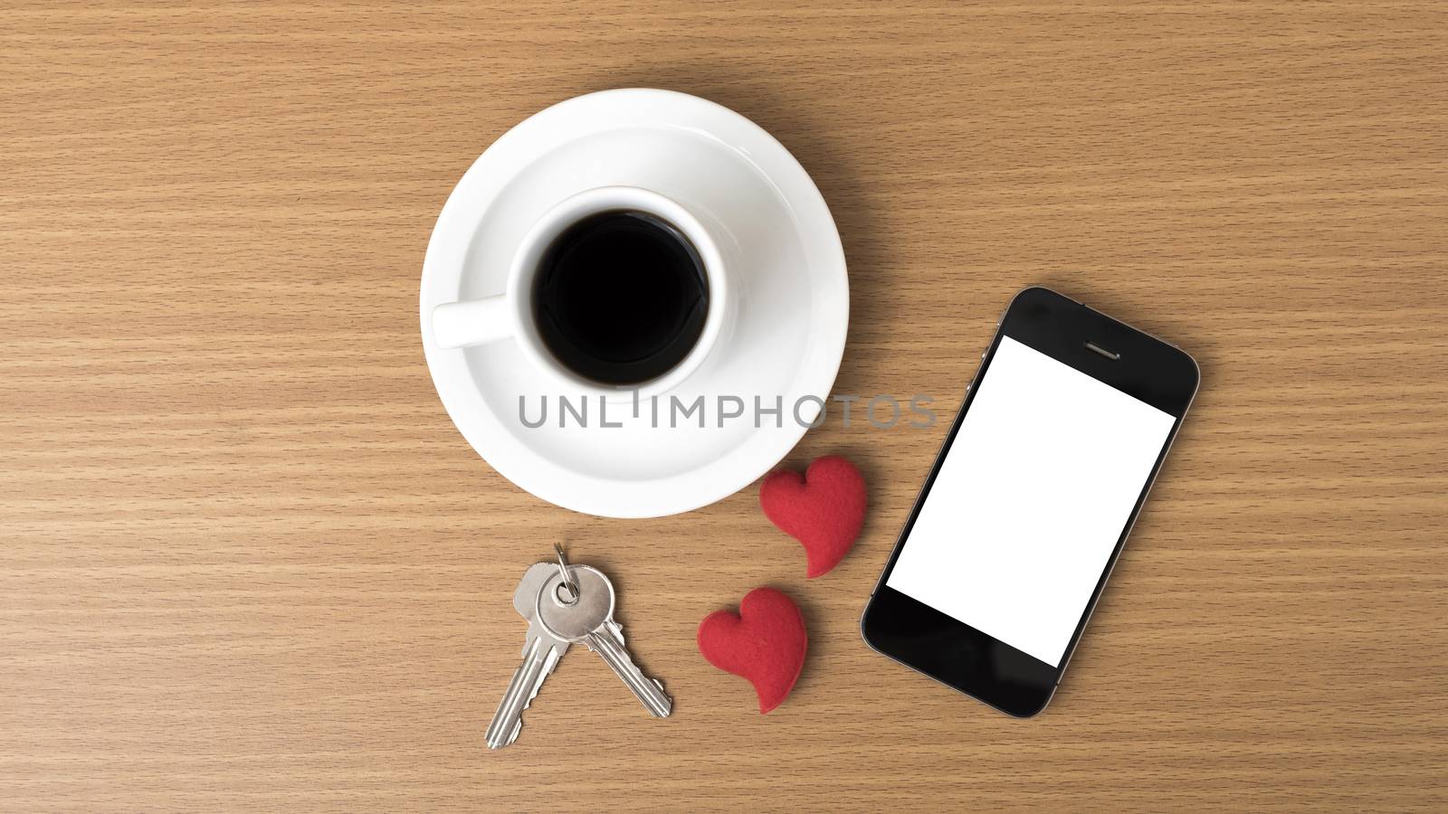 coffee phone key and heart on wood table background