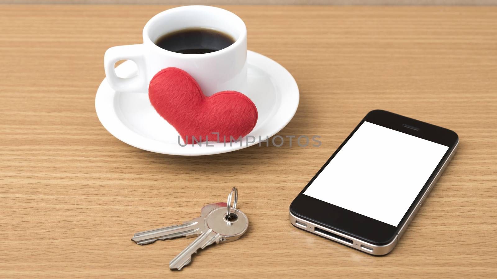 coffee phone key and heart on wood table background