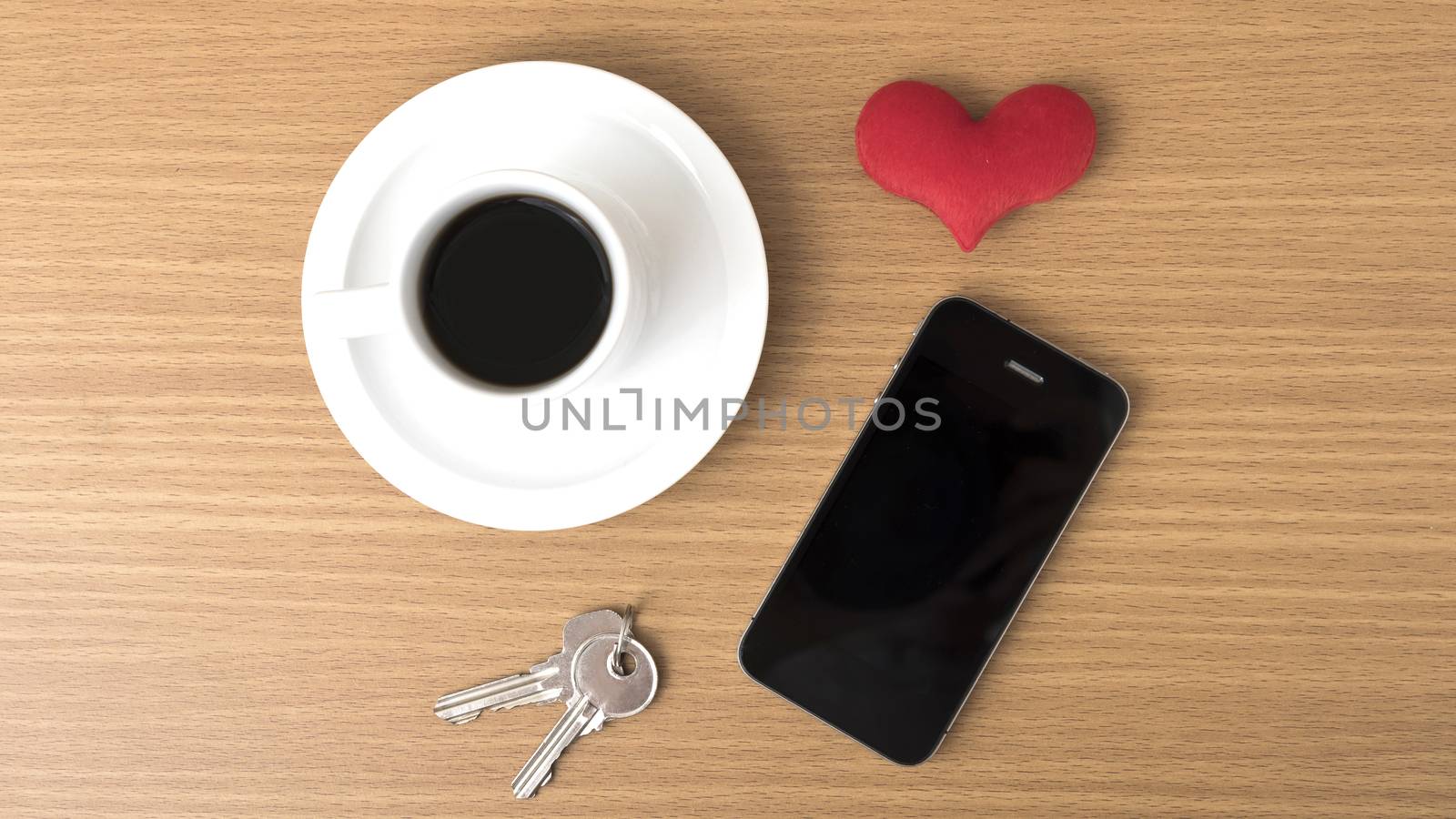coffee phone key and heart on wood table background