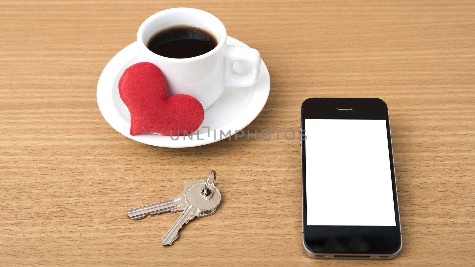 coffee phone key and heart on wood table background