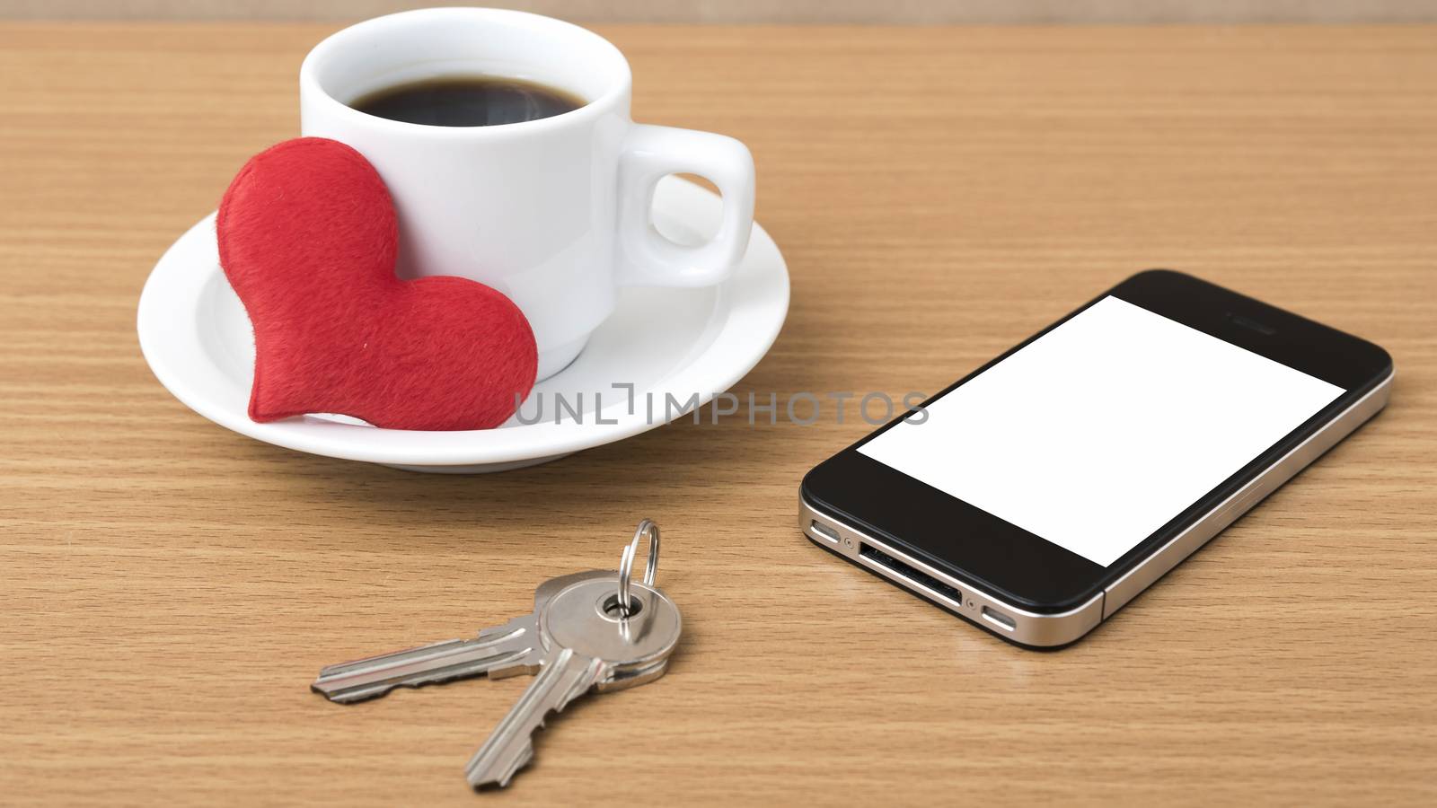 coffee phone key and heart on wood table background