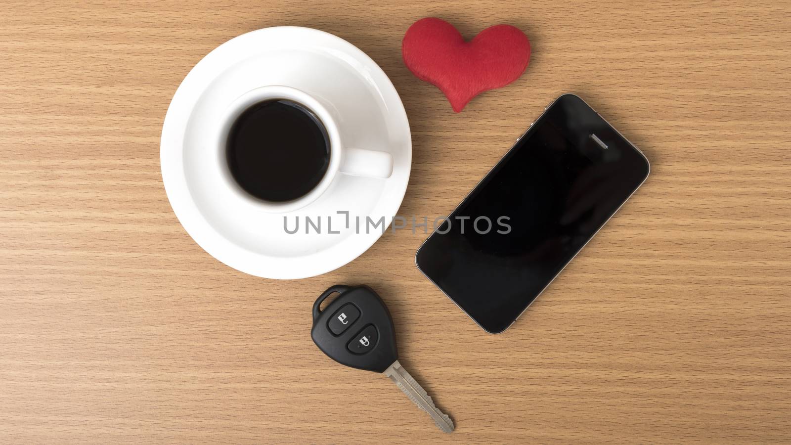 coffee phone car key and heart on wood table background