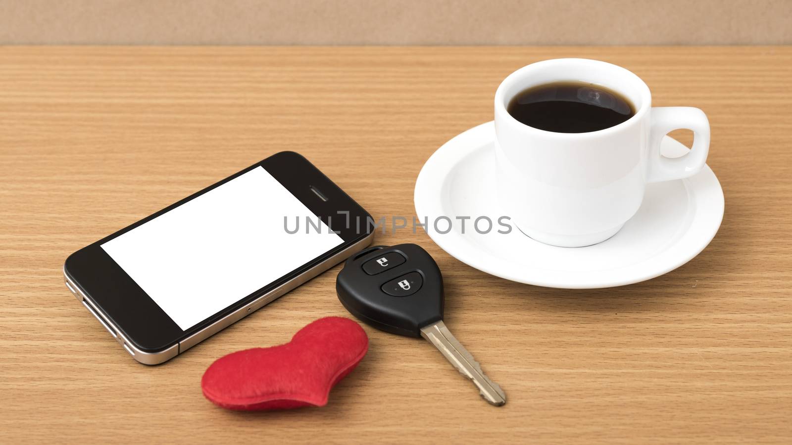 coffee phone car key and heart on wood table background