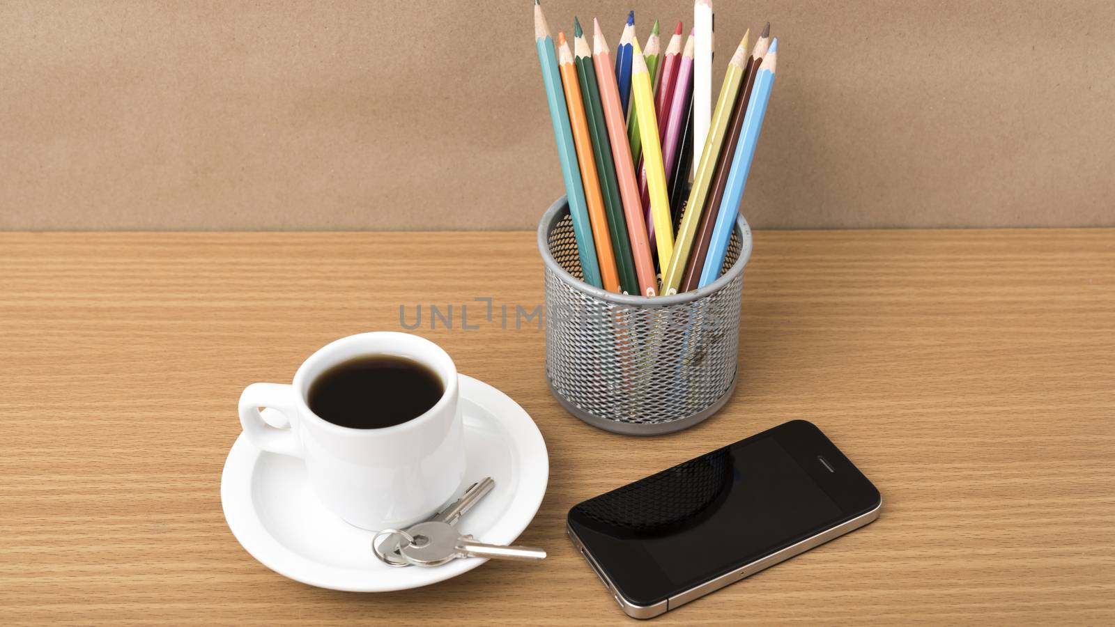 coffee,phone,key and pencil on wood table background