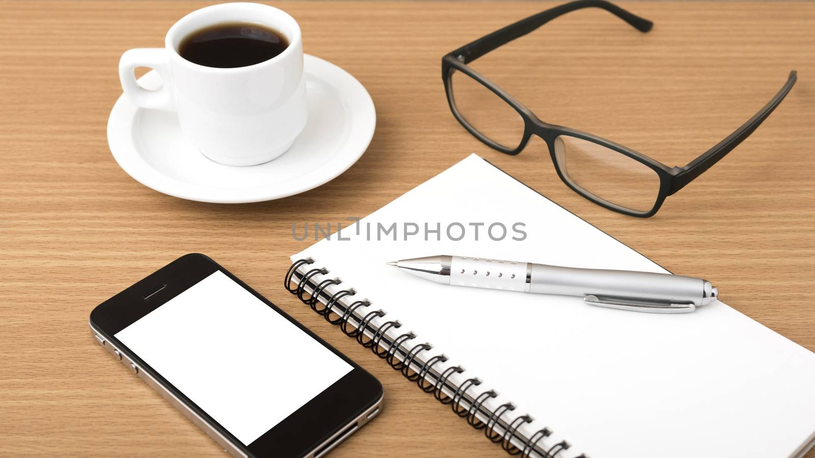 coffee,phone,notepad and eyeglasses on wood table background