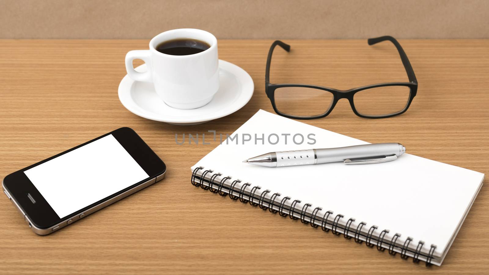 coffee,phone,notepad and eyeglasses on wood table background