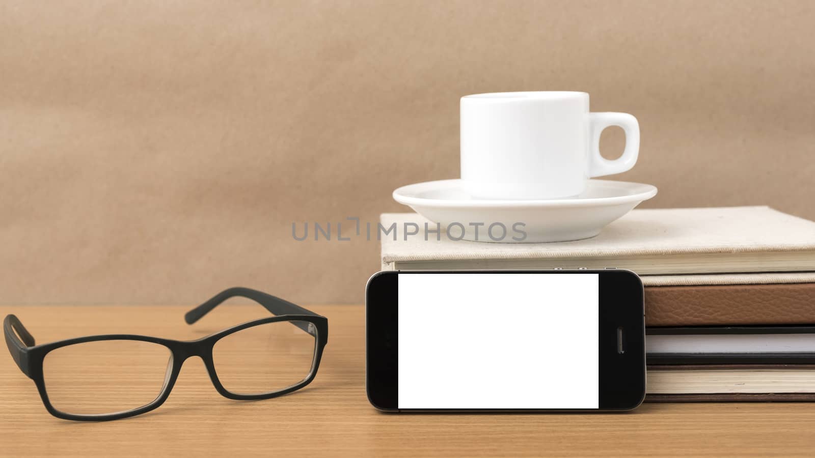 coffee,phone,stack of book and eyeglasses on wood table background