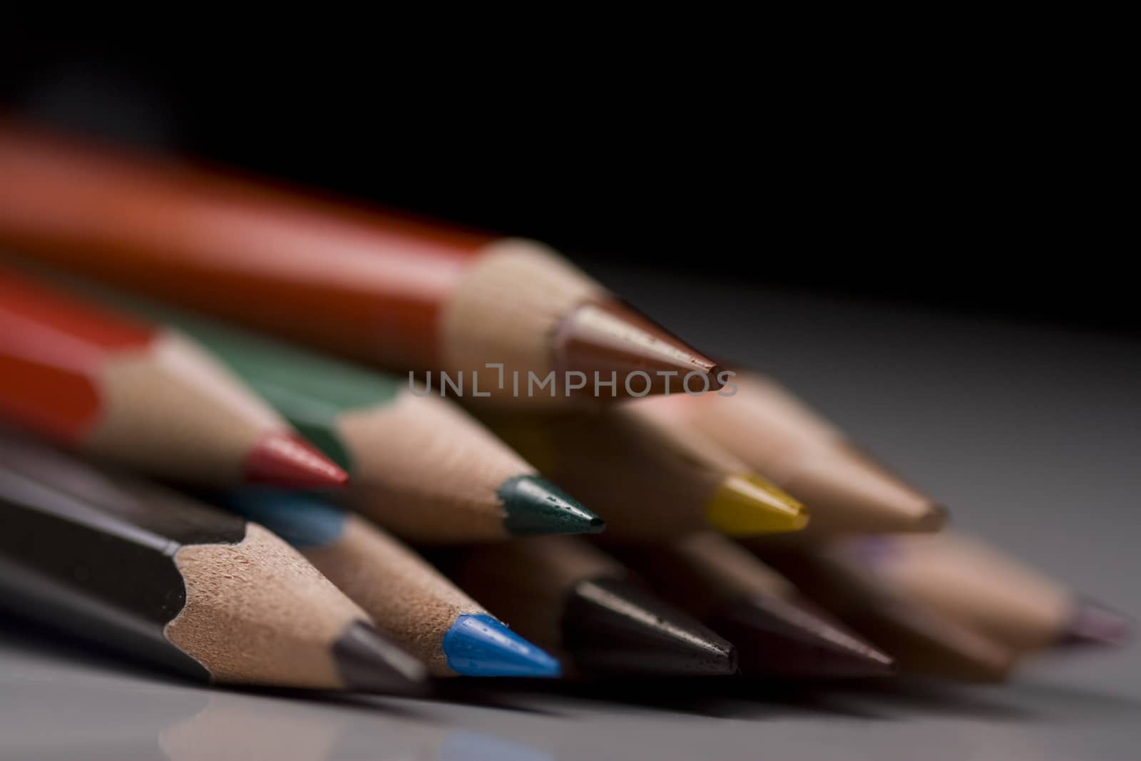Group of colored pencils with shallow depth of field on black background