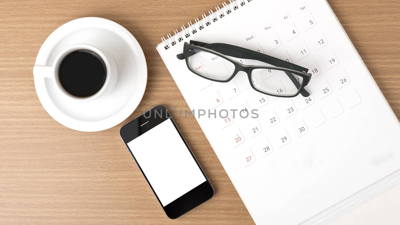 coffee,phone,eyeglasses and calendar on wood table background