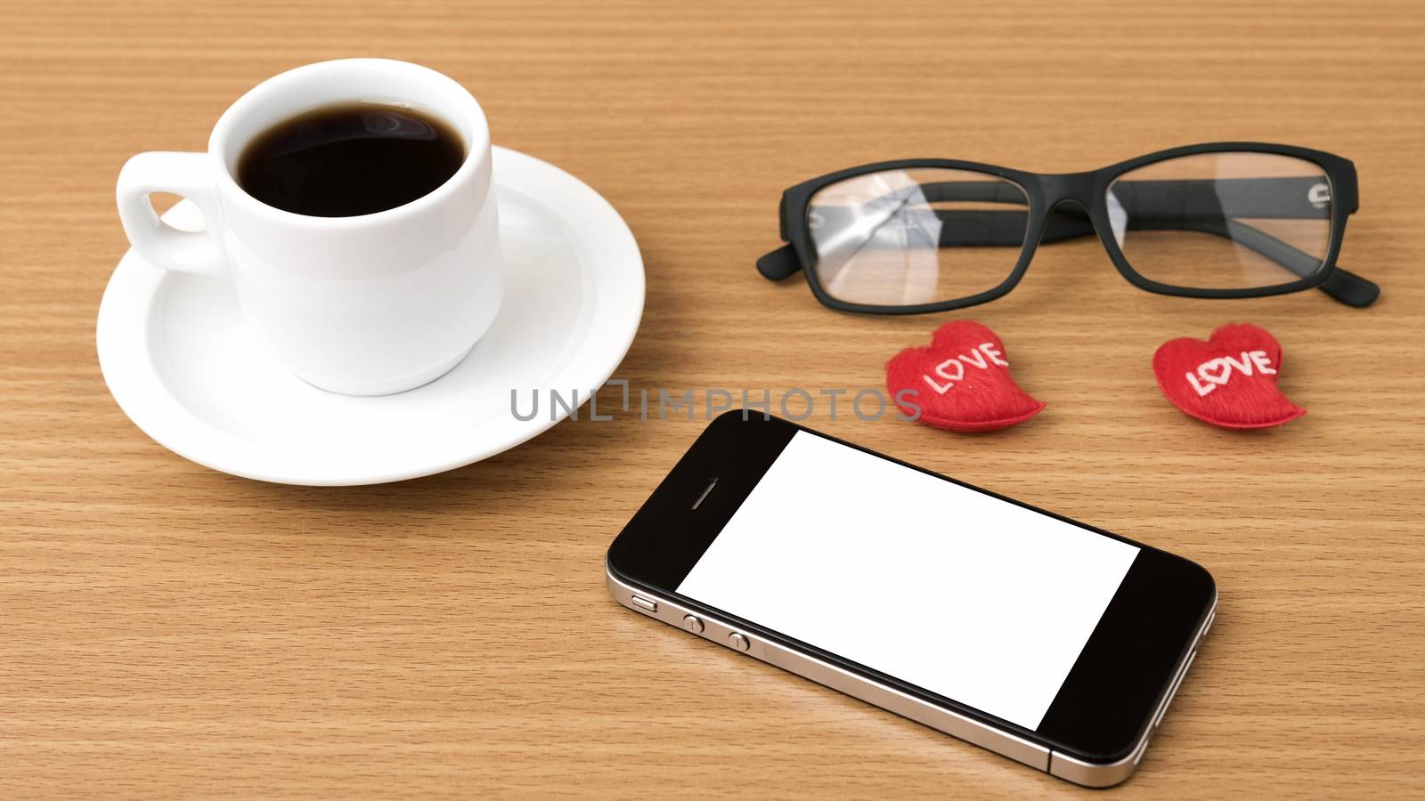 coffee,phone,eyeglasses and heart on wood table background
