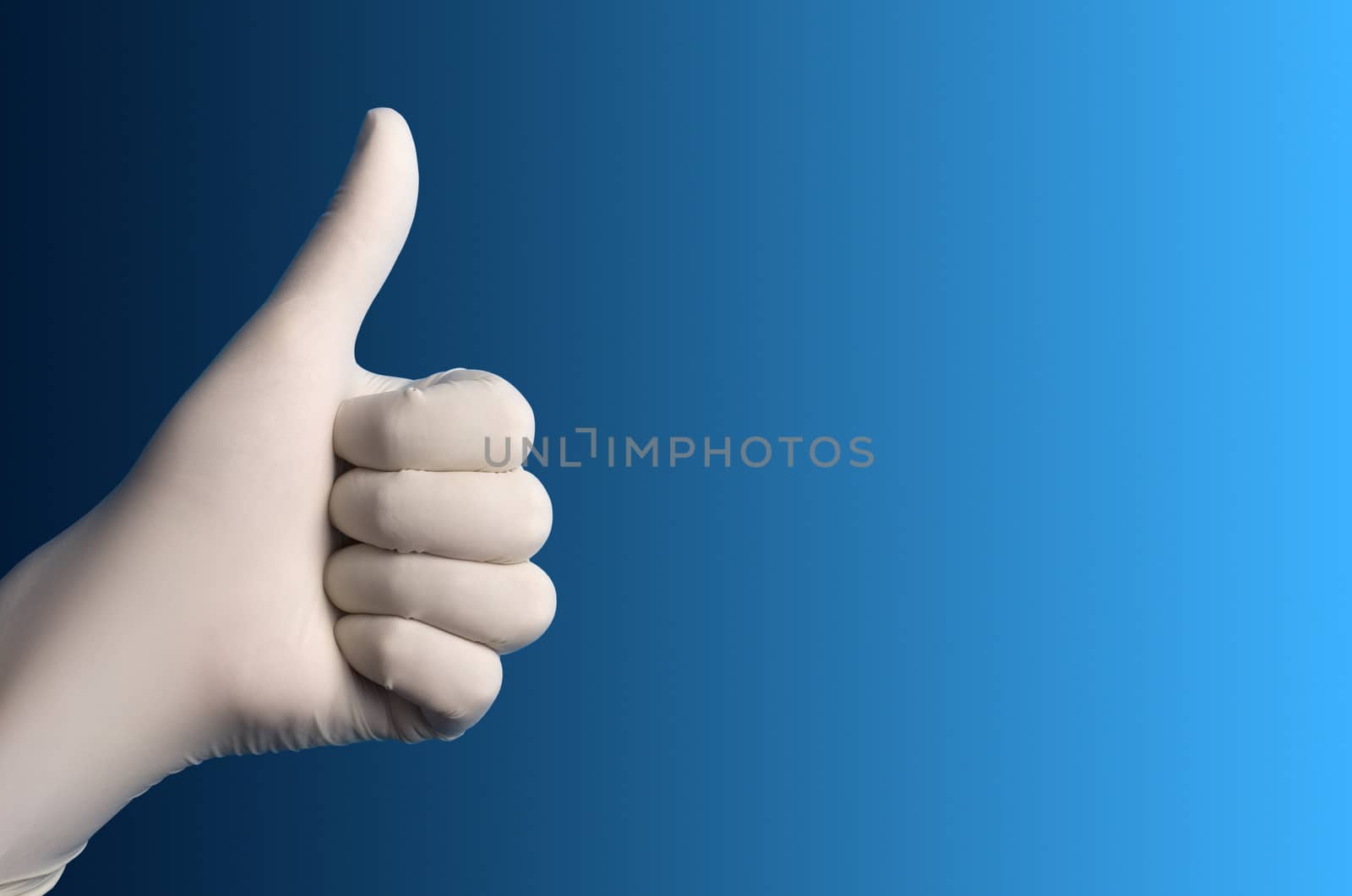 Hand with a white surgical glove showing the ok sign against a blue background