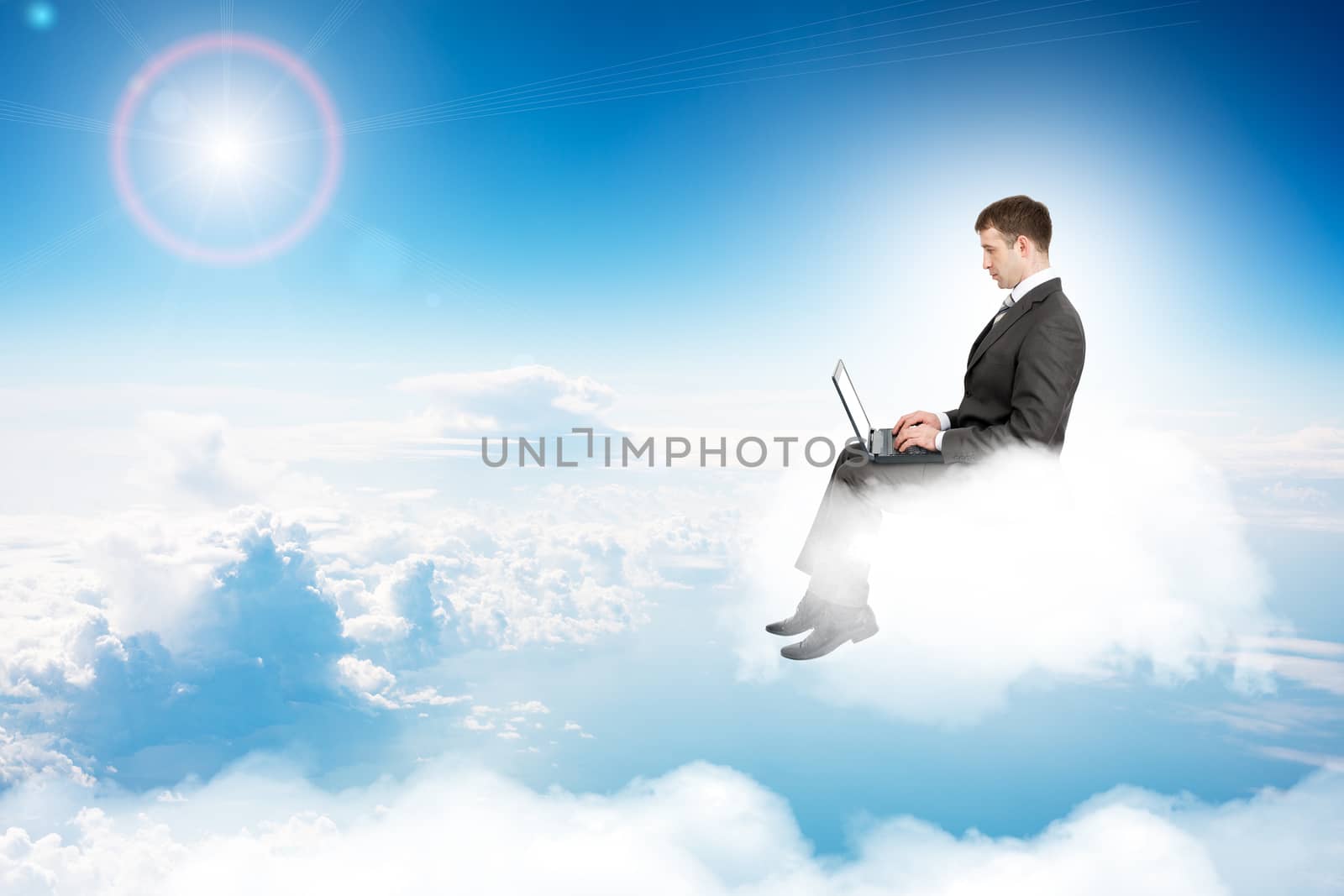 Businessman working on laptop and sitting on cloud in sky