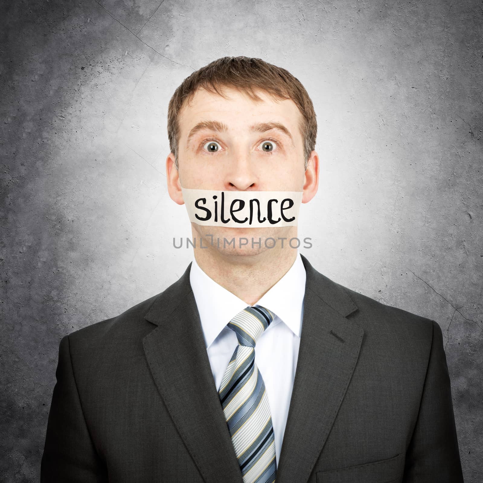 Businessman with tape over his mouth with word silence isolated on white background