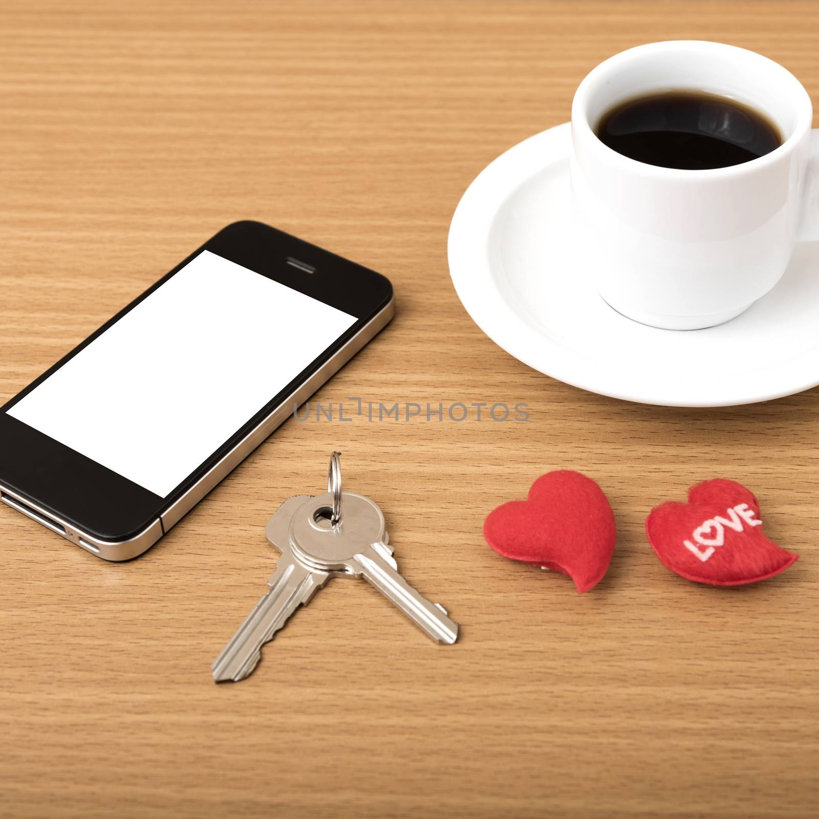 coffee phone key and heart on wood table background