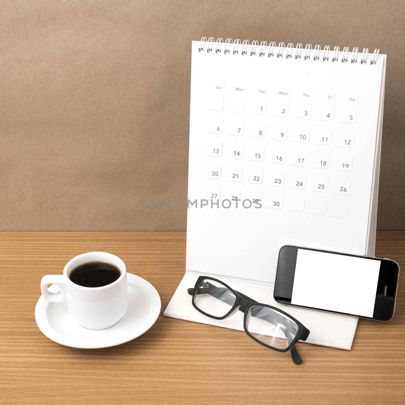 coffee,phone,eyeglasses and calendar on wood table background