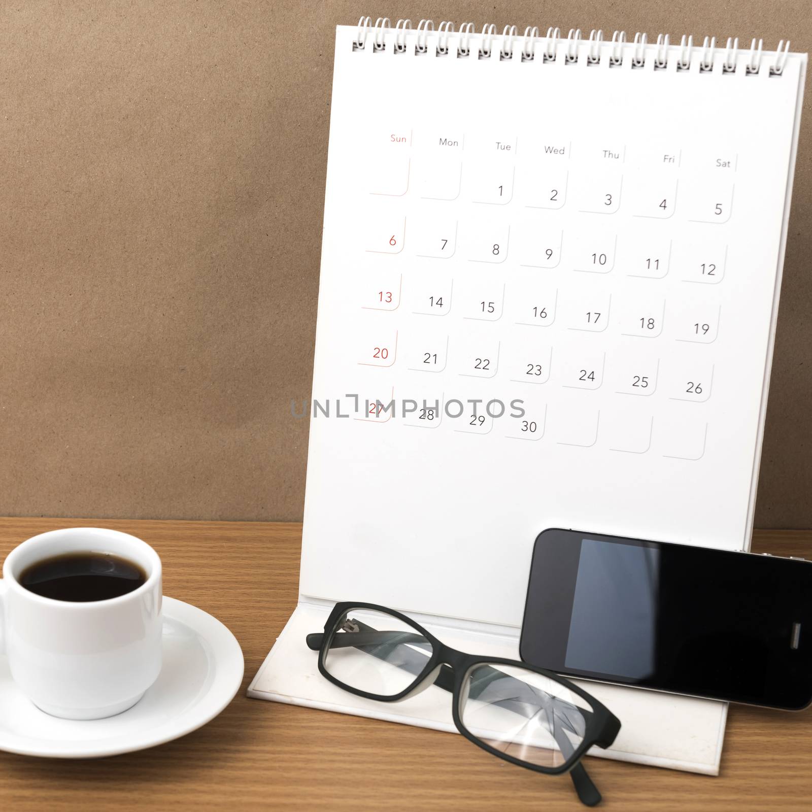 coffee,phone,eyeglasses and calendar on wood table background