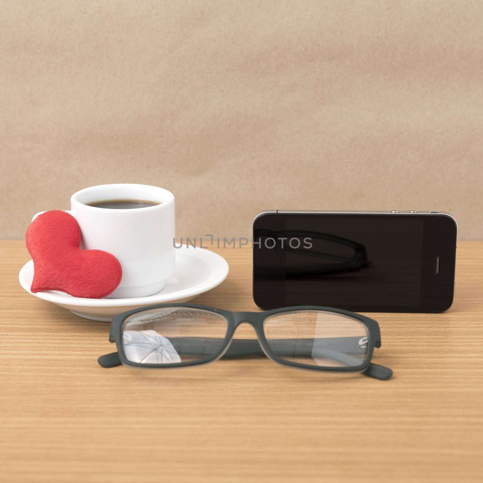 coffee,phone,eyeglasses and heart on wood table background