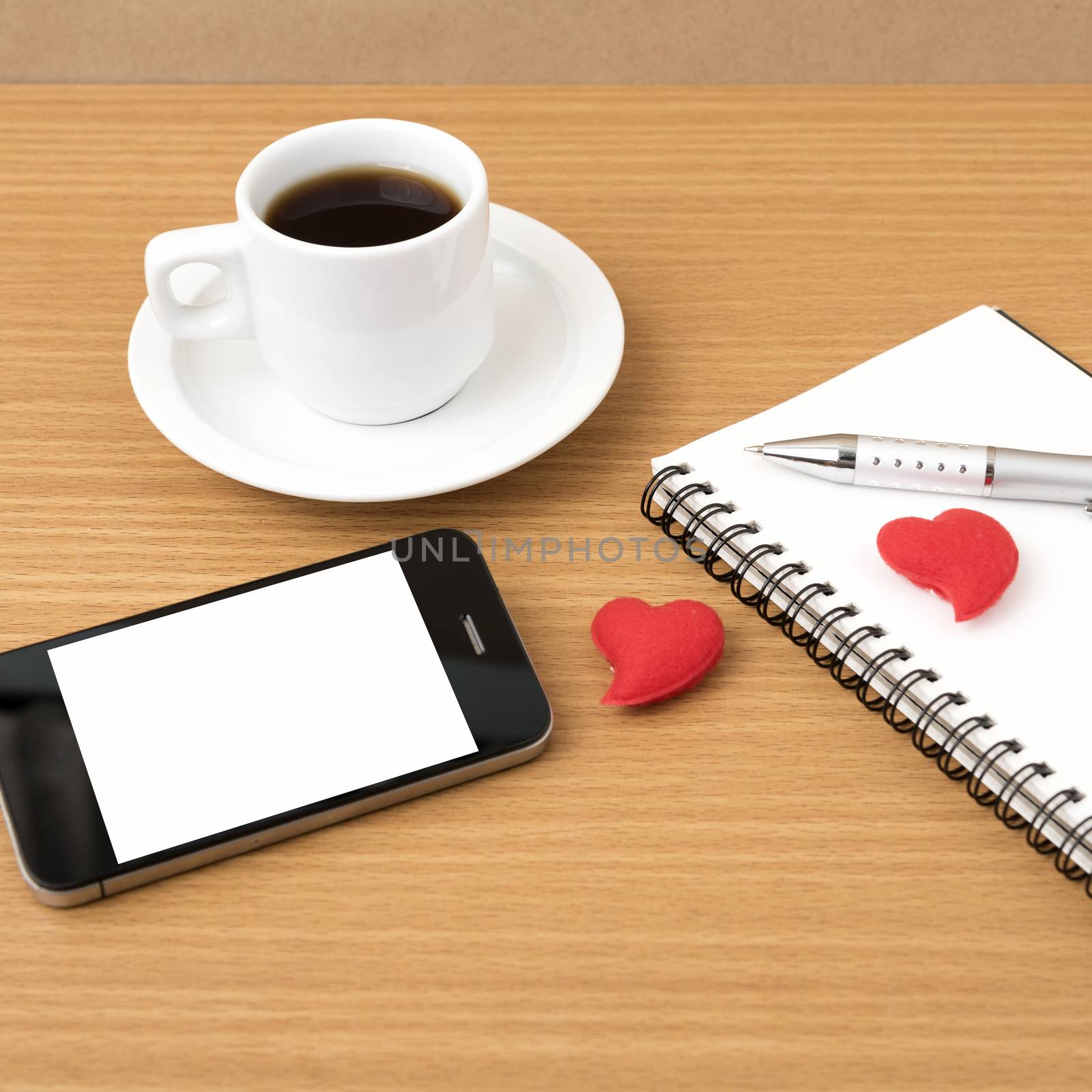 coffee,phone,notepad and heart on wood table background