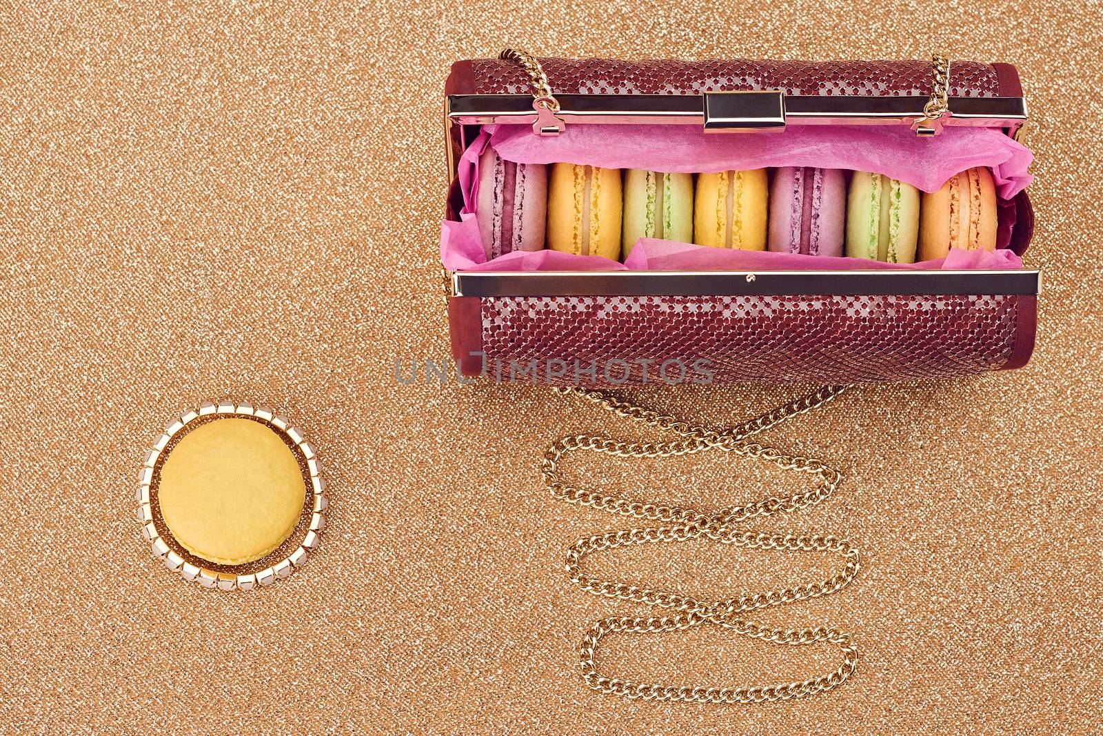 Macarons in shiny fashion handbag on gold.Vintage by 918